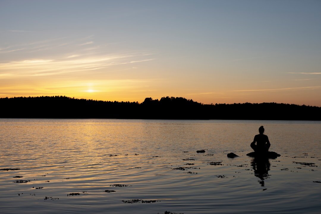 person meditating in morning light