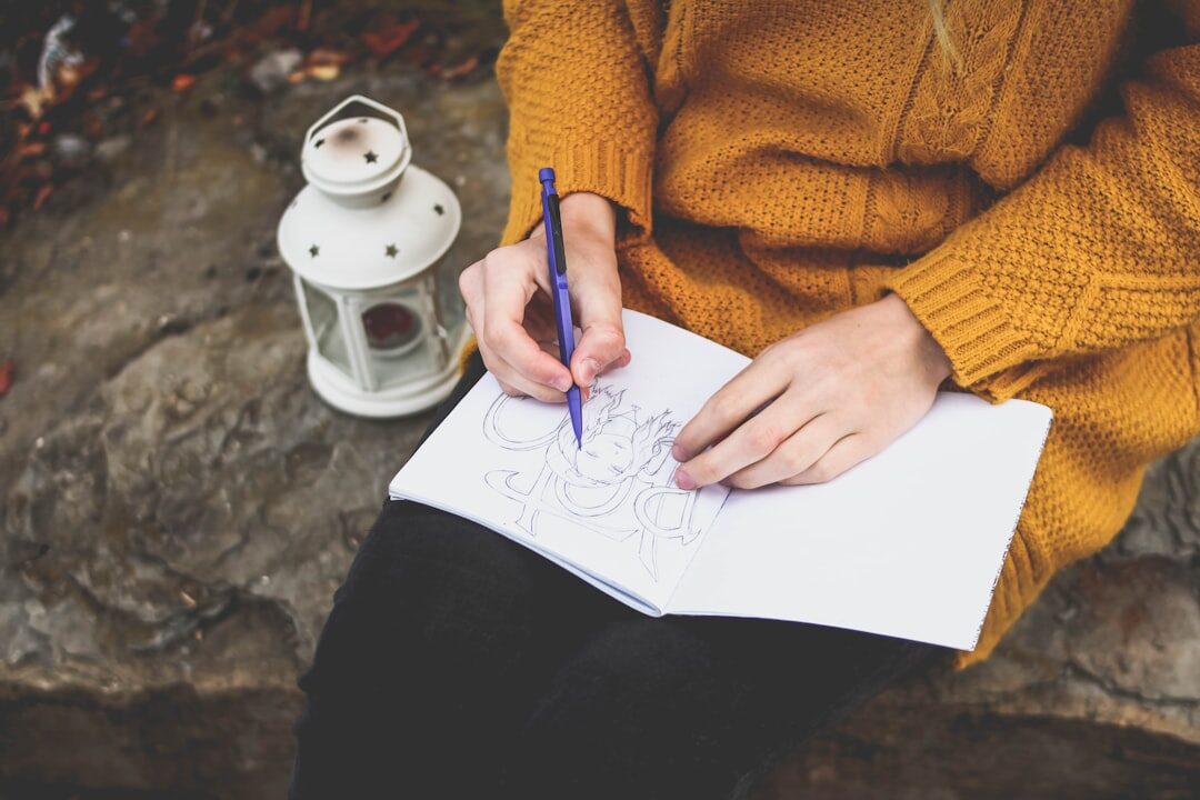 person writing gratitude list