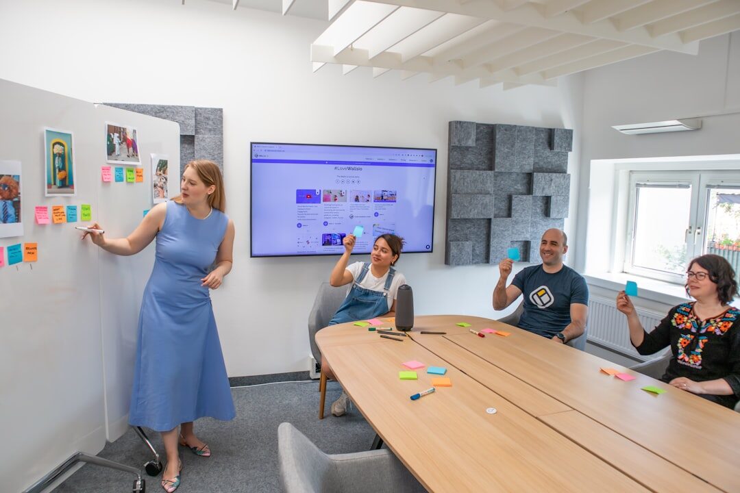 People brainstorming together with sticky notes on a glass wall